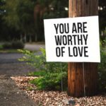panneau sur un arbre sur lequel il est écrit "You are worthy of love" (ce qui veut dire "tu mérites l'amour" ;) )